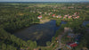 Aerial drone view of Germendorfer Waldsee lake in Oranienburg, Germany.